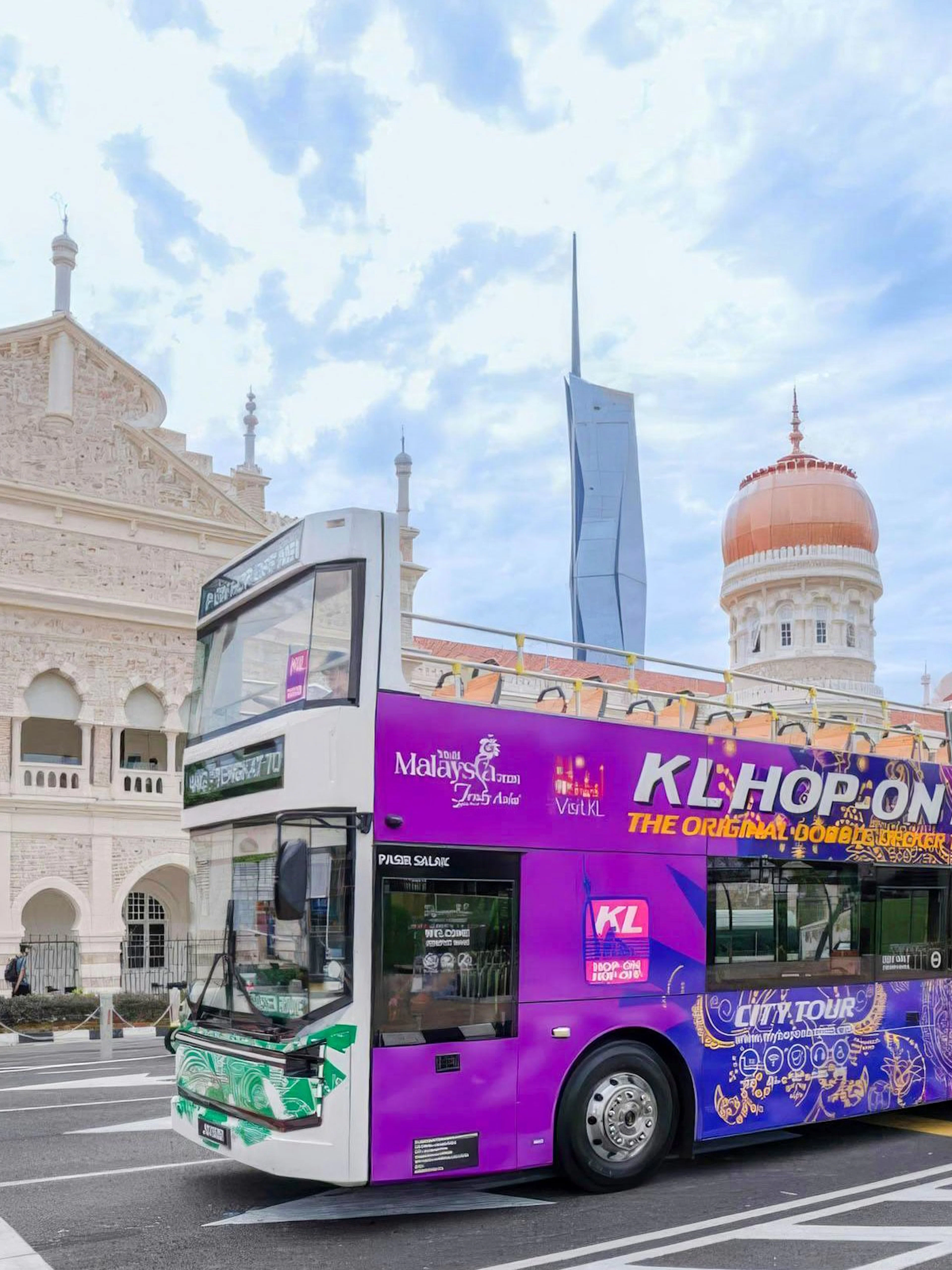 Open-top bus in front of Sultan Abdul Samad Building, Kuala Lumpur.