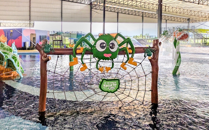 Spider-shaped play structure at Monkey Splash Zone water park.