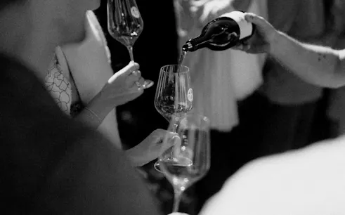 Wine being poured into glasses during a blind tasting event in Barcelona.