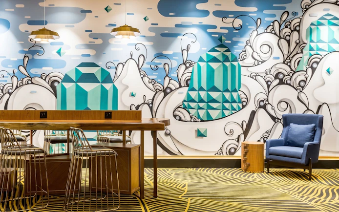 Plaza Premium Lounge seating area with artistic mural at Rio de Janeiro Airport, T2.