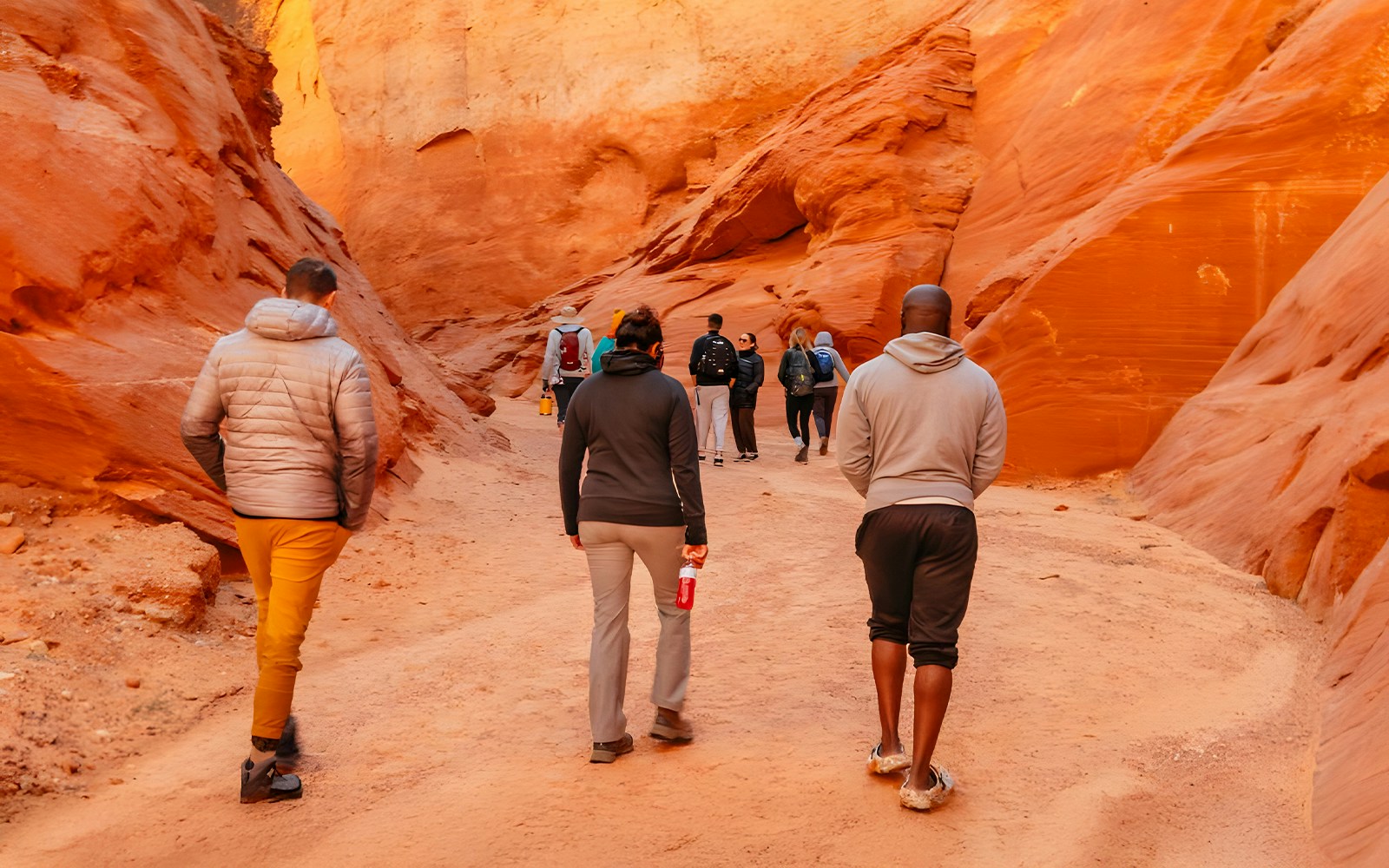 Tourists walking through the narrow, red rock formations of Antelope Canyon.