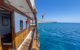 Person jumping off a boat into the Blue Lagoon near Protaras, Cyprus.