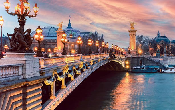 Pont Alexandre III illuminated at sunset during an evening cruise in Paris.