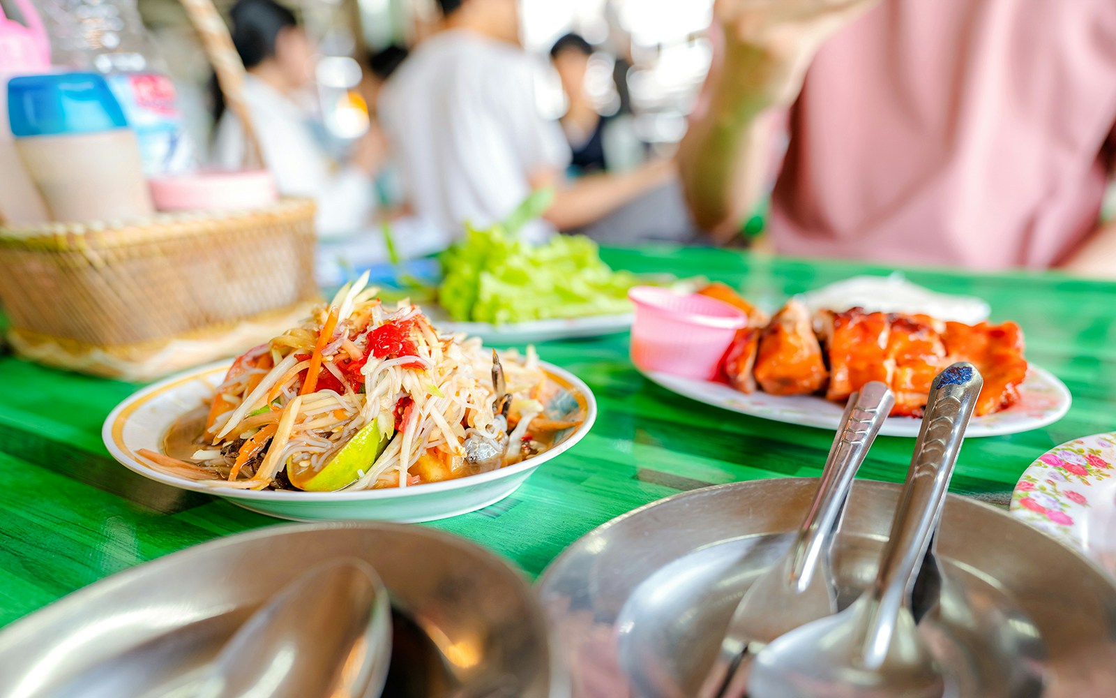 Plate of Thai papaya salad and grilled chicken at a local restaurant.
