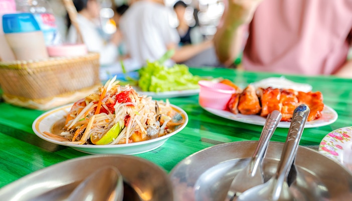 Plate of Thai papaya salad and grilled chicken at a local restaurant.