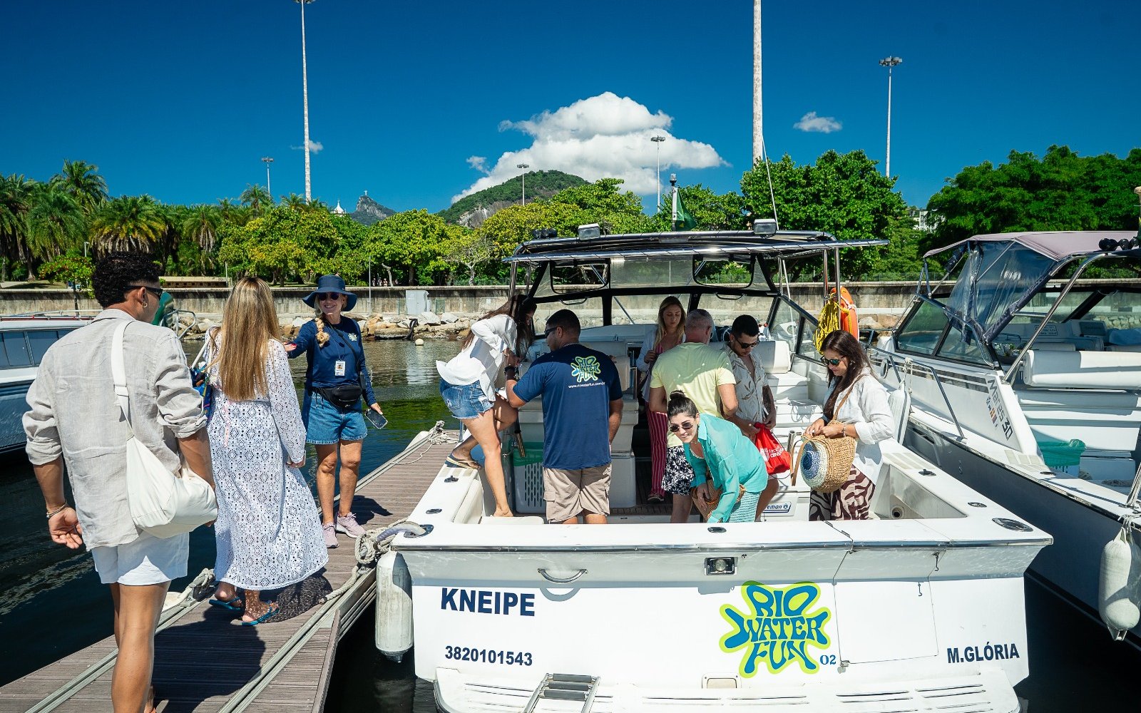 Tourists boarding a cruise boat at a marina in Rio de Janeiro.