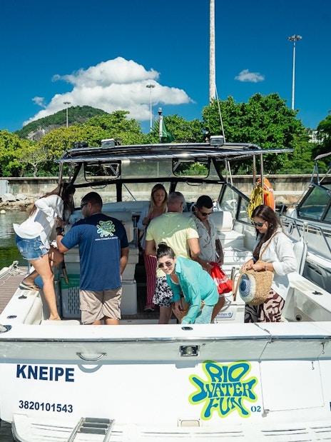 Tourists boarding a cruise boat at a marina in Rio de Janeiro.