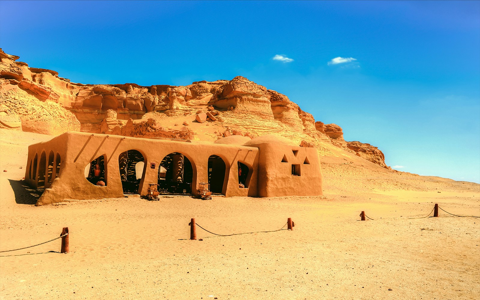 Mudbrick structure in Wadi Al Hitan, Al Fayoum, Egypt, with desert cliffs in the background.