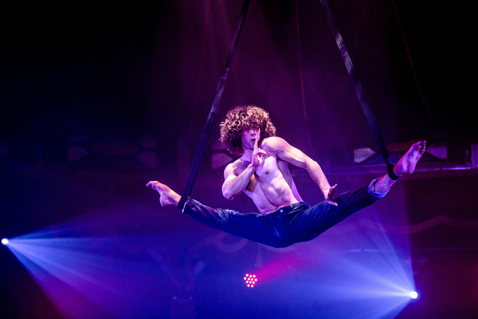 Performer suspended in mid-air during Atomic Saloon Show.