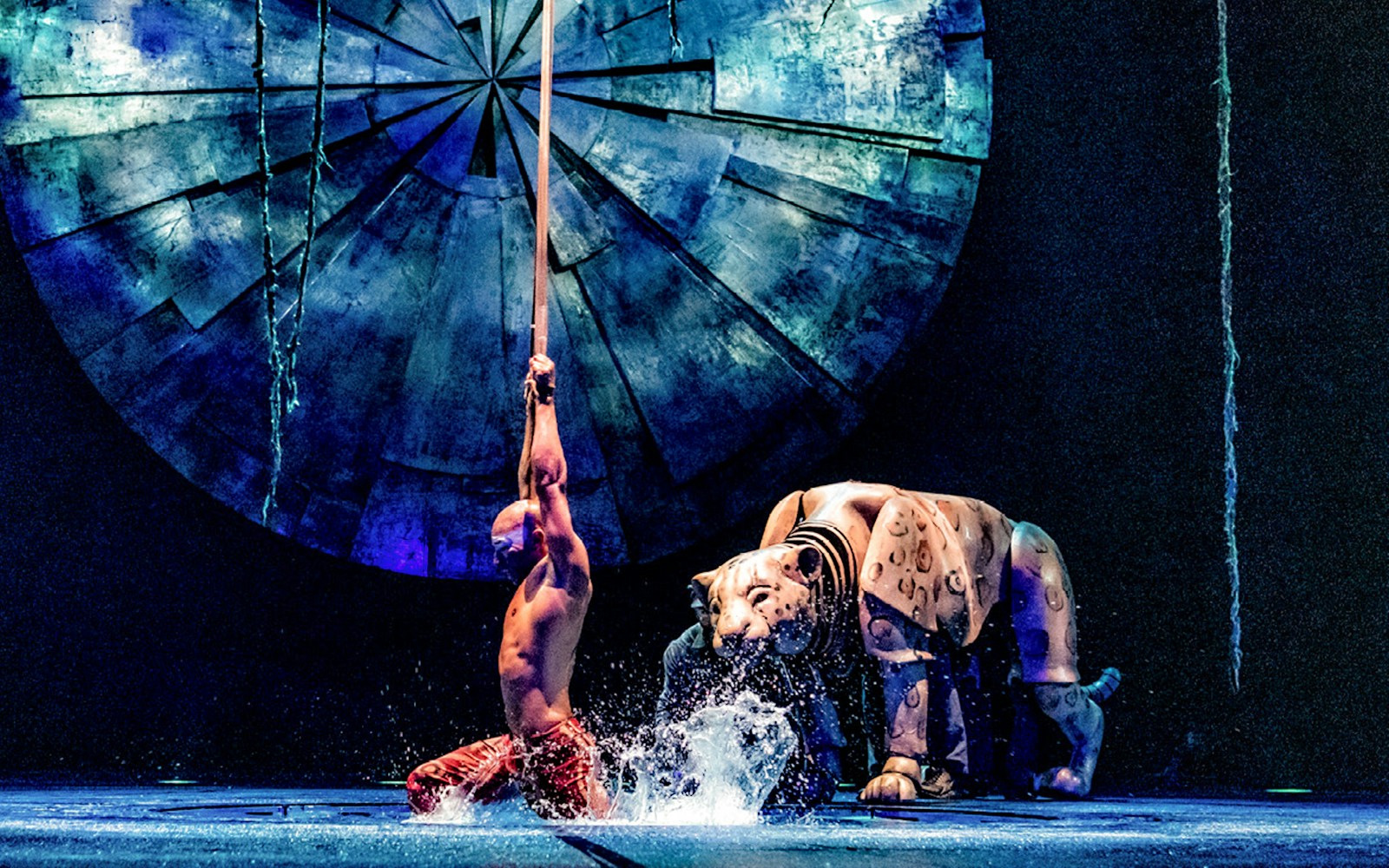 Performer with pole and tiger puppet in Cirque du Soleil: LUZIA, New York.