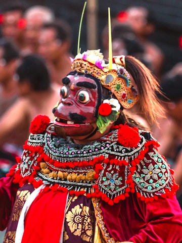Performer in traditional costume at Uluwatu Kecak Fire Dance, Bali.