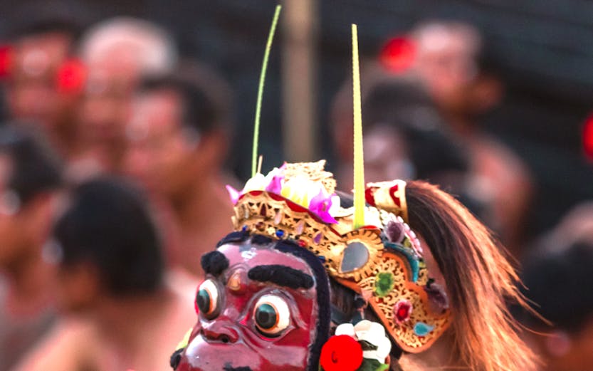 Performer in traditional costume at Uluwatu Kecak Fire Dance, Bali.