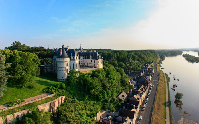 Aerial view of Chaumont sur Loire Castle with surrounding greenery and nearby river.