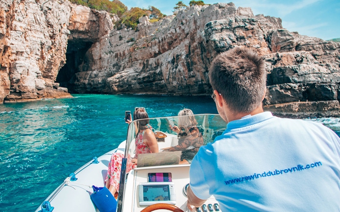 Private boat approaching Blue Cave, Dubrovnik, with passengers enjoying the view.