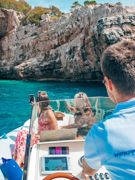 Private boat approaching Blue Cave, Dubrovnik, with passengers enjoying the view.