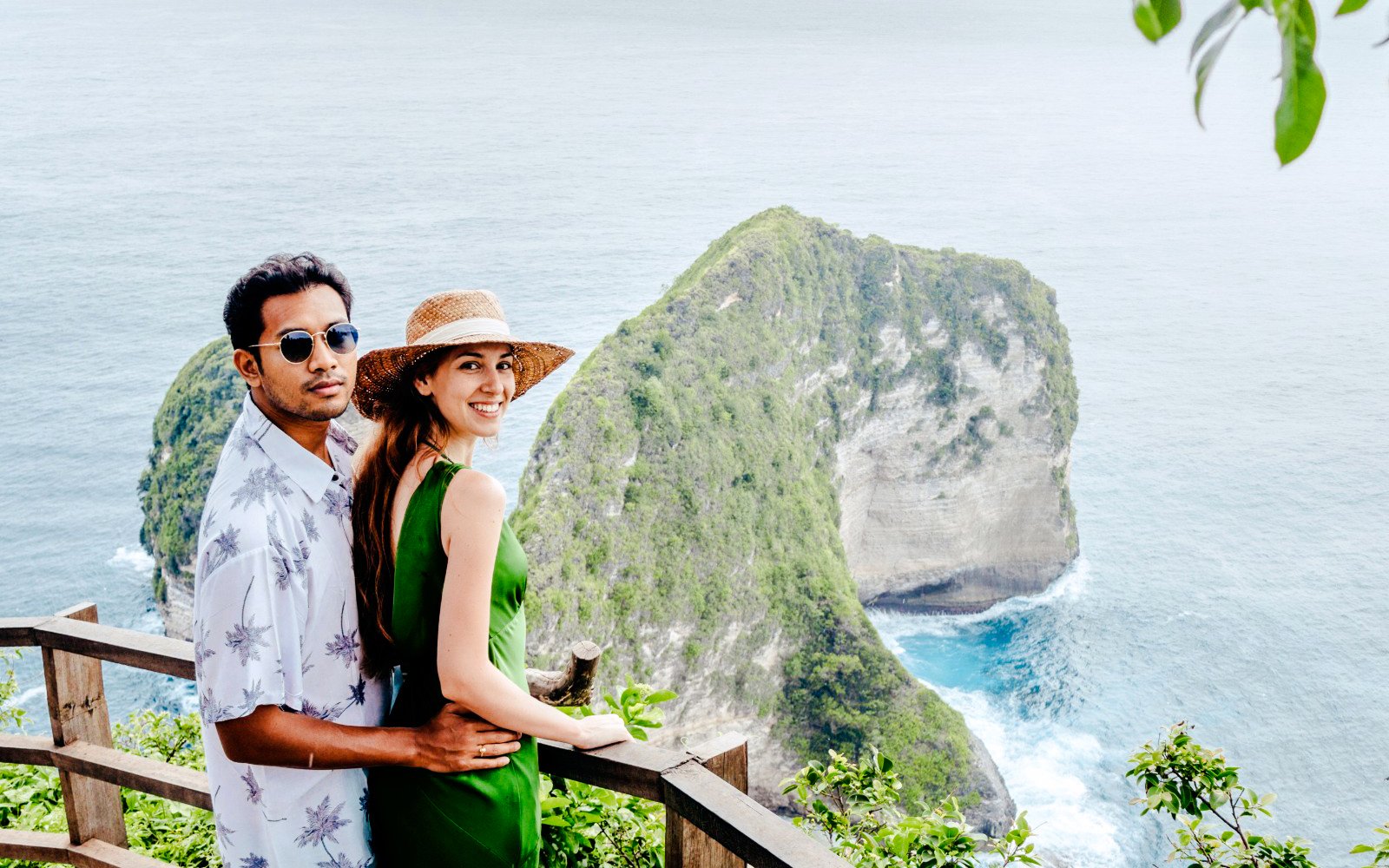 Couple enjoying the view of Kelingking Beach cliffs on West Nusa Penida Island tour.