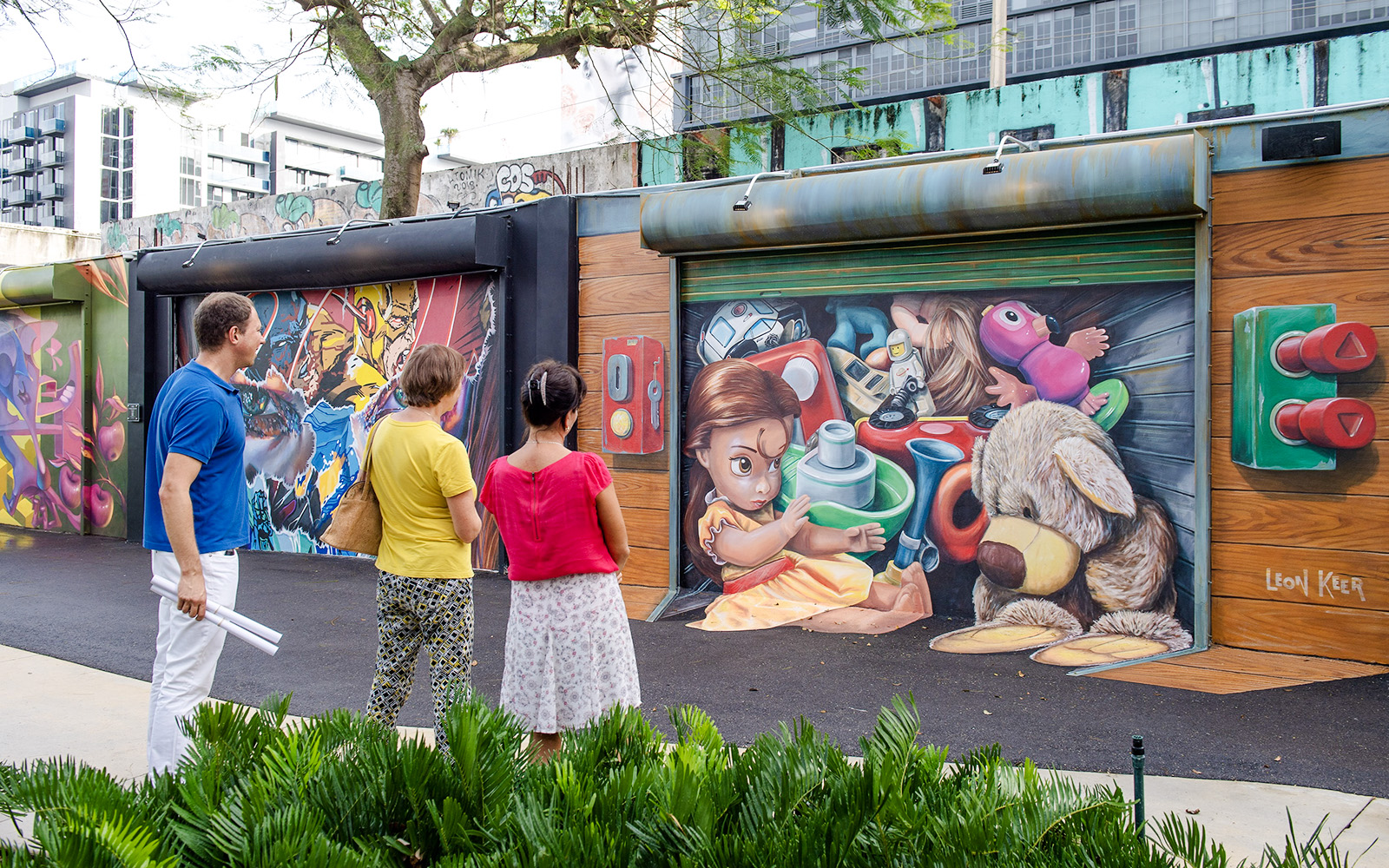 Visitors admiring colorful murals at Wynwood Walls Museum in Miami.
