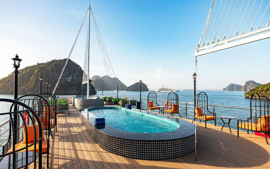 La Casta cruise deck with pool, Ha Long Bay limestone islands in background.