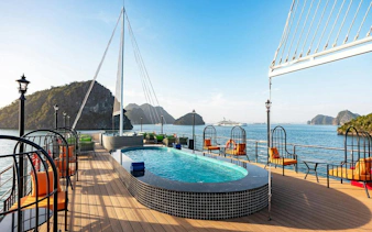 La Casta cruise deck with pool, Ha Long Bay limestone islands in background.