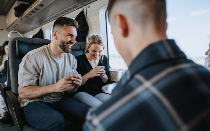People playing cards on a train in Europe.