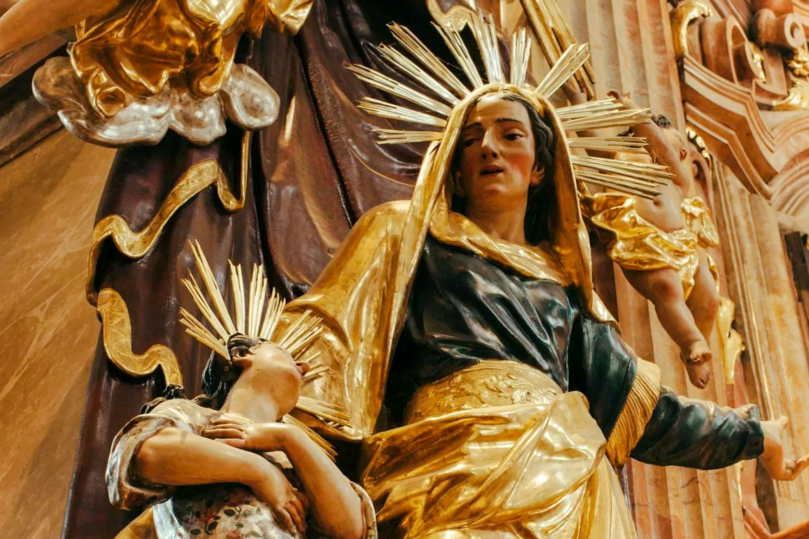 Statue of a woman and child with golden halos inside St Anne's Church.