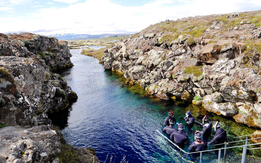 Snorkelers in Silfra rift, Thingvellir National Park, Iceland.