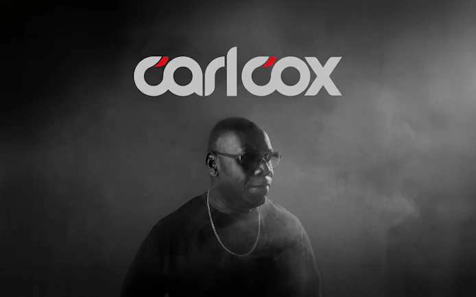 DJ performing in Ibiza with Carlcox logo in the background.