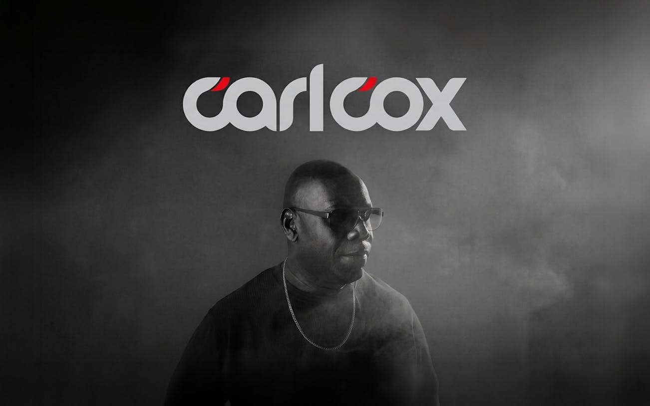 DJ performing in Ibiza with Carlcox logo in the background.