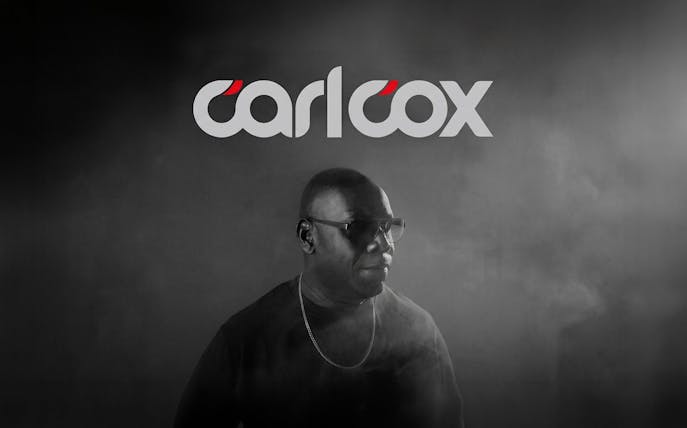 DJ performing in Ibiza with Carlcox logo in the background.