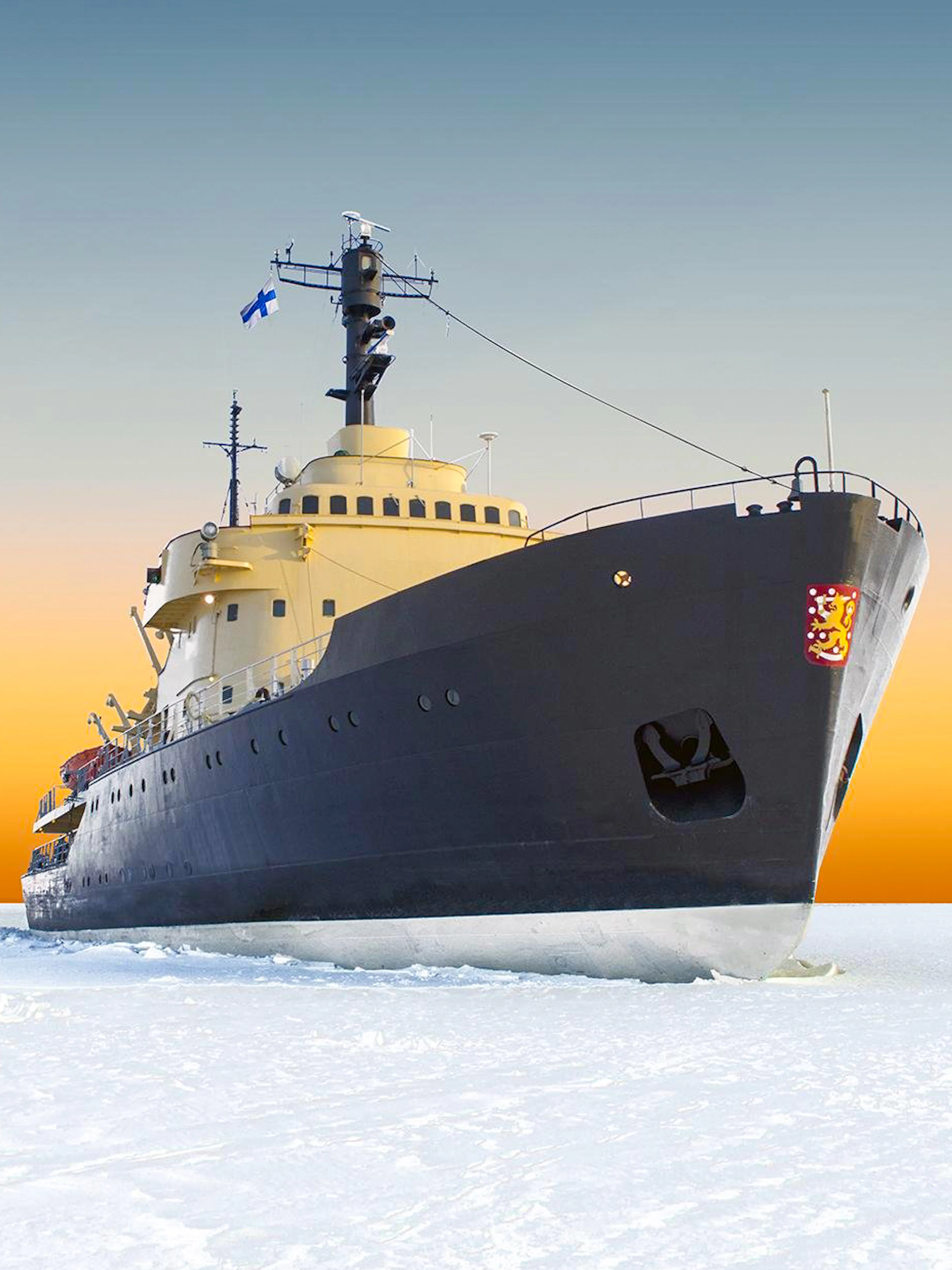 Icebreaker Sampo cruising through frozen sea at sunrise in Finland.