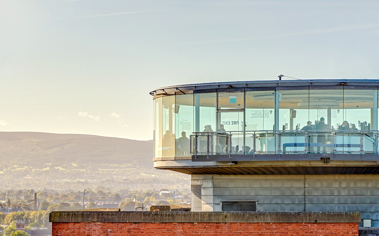 Gravity Bar exterior with panoramic views of Dublin cityscape and distant hills.