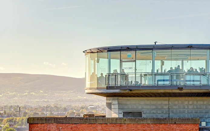 Gravity Bar exterior with panoramic views of Dublin cityscape and distant hills.