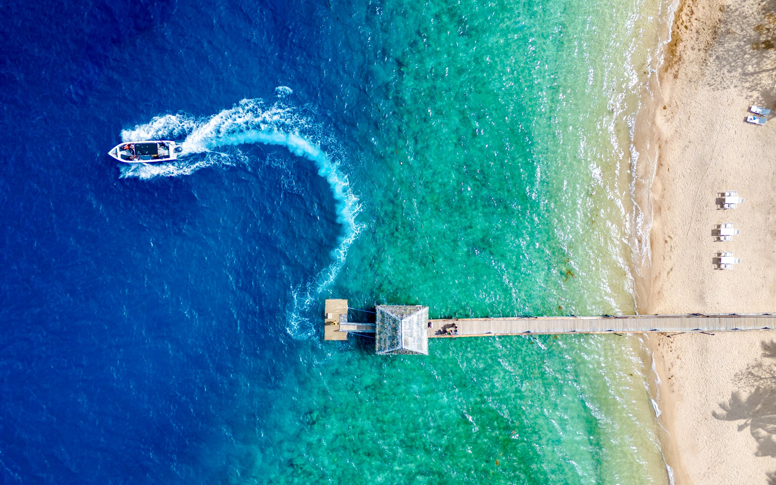Aerial view of Malolo Island resort port with speedboat in Fiji.