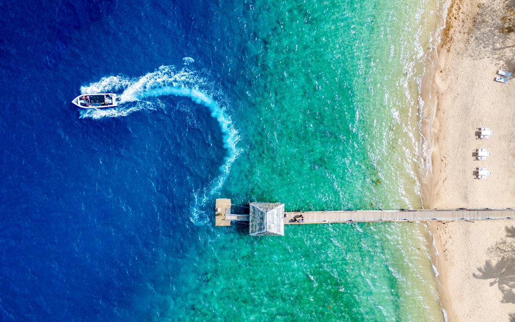 Aerial view of Malolo Island resort port with speedboat in Fiji.