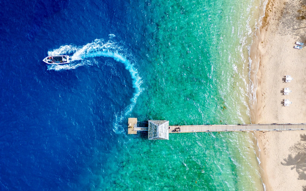 Aerial view of Malolo Island resort port with speedboat in Fiji.