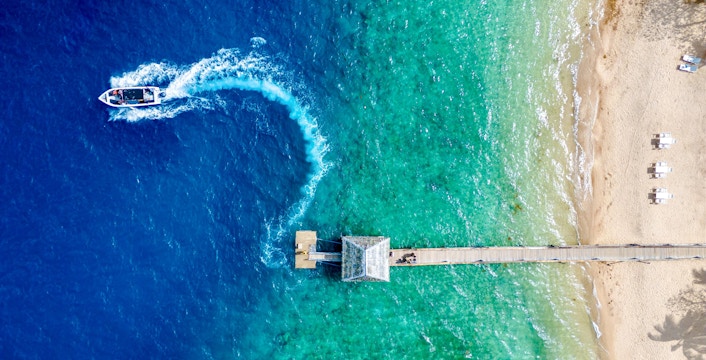Aerial view of Malolo Island resort port with speedboat in Fiji.