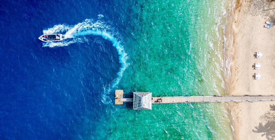 Aerial view of Malolo Island resort port with speedboat in Fiji.