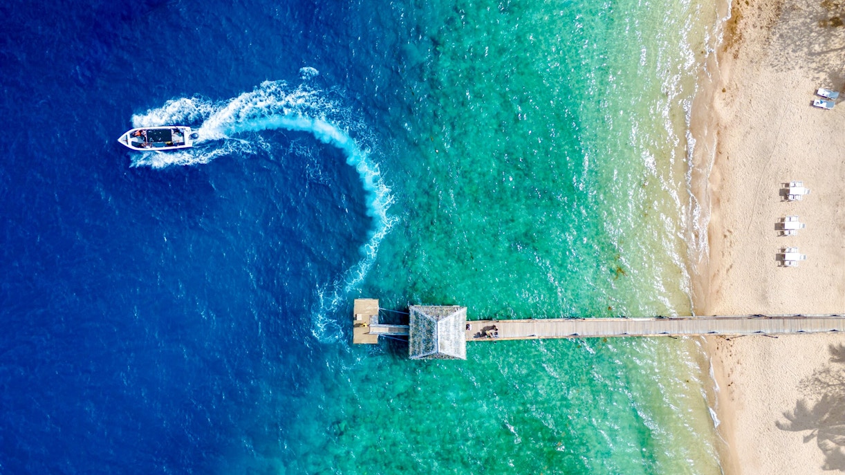 Aerial view of Malolo Island resort port with speedboat in Fiji.