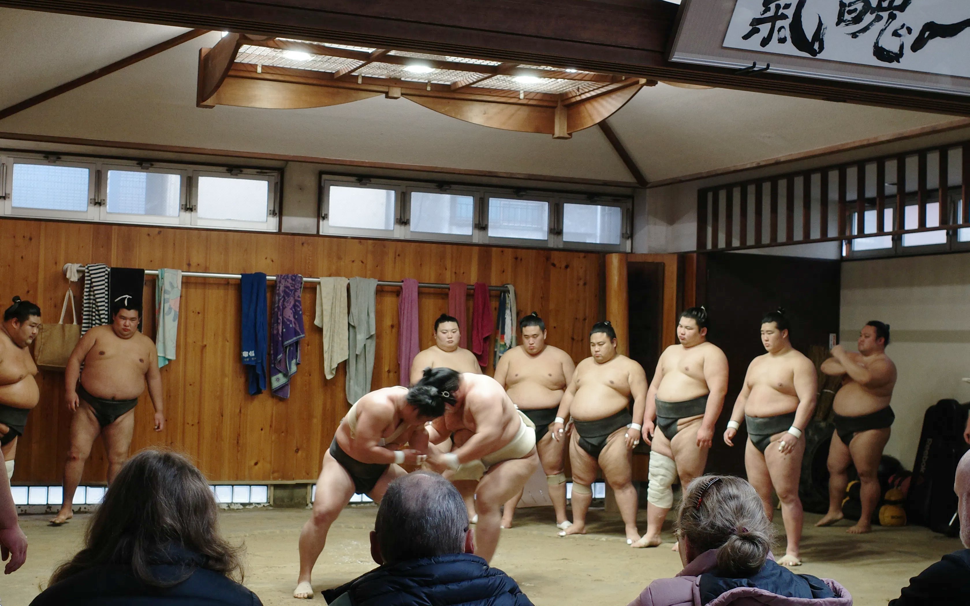 Sumo wrestlers practicing in a dojo during the Premium Professional Sumo Morning Practice in Asakusa.