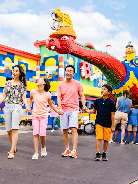 Guests enjoying a day at Legoland New York with colorful Lego structures.