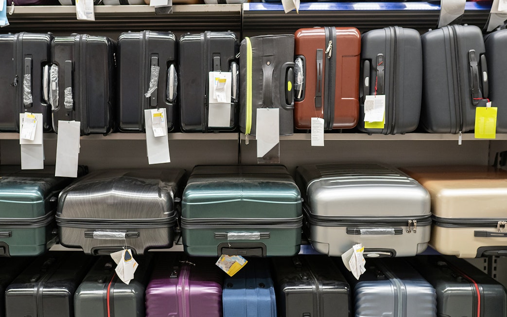 Suitcases displayed on store shelves.