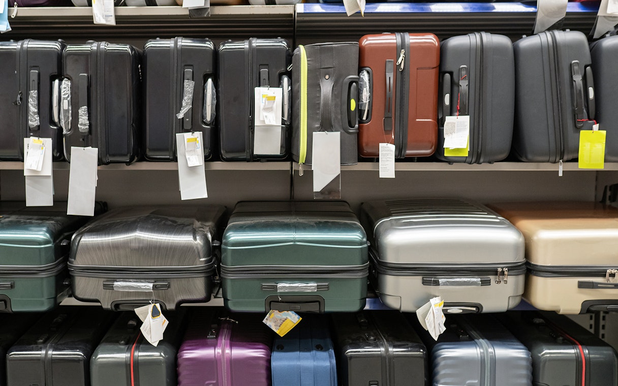Suitcases displayed on store shelves.