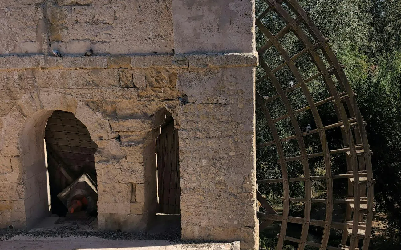 Ancient waterwheel and stone structure in Córdoba, part of the self-guided city exploration game.