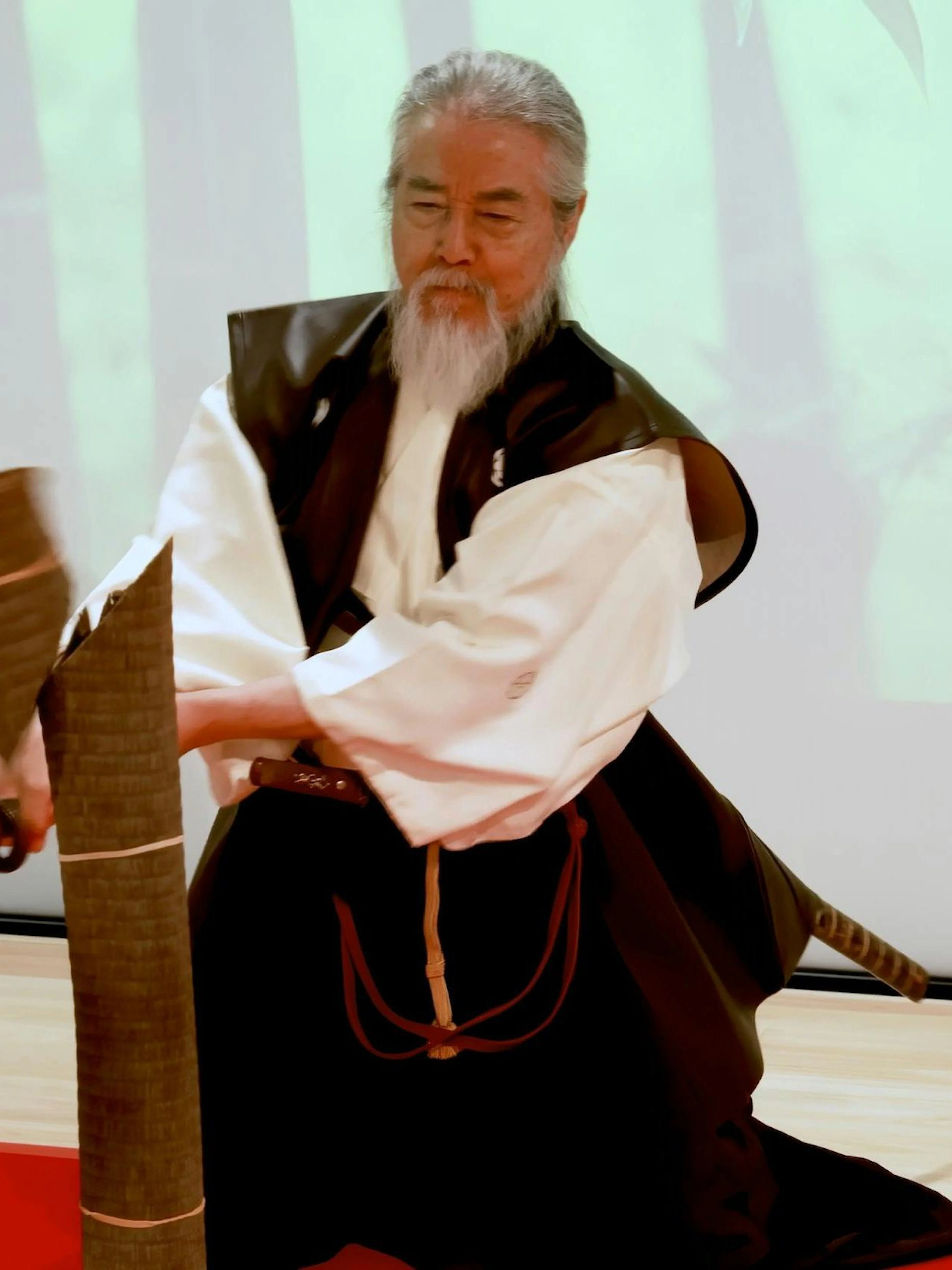 Samurai master demonstrating sword technique in Kyoto experience.