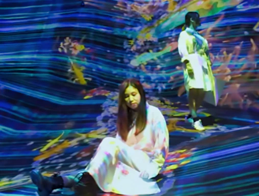 Visitors interacting with digital art installation at teamLab SuperNature.