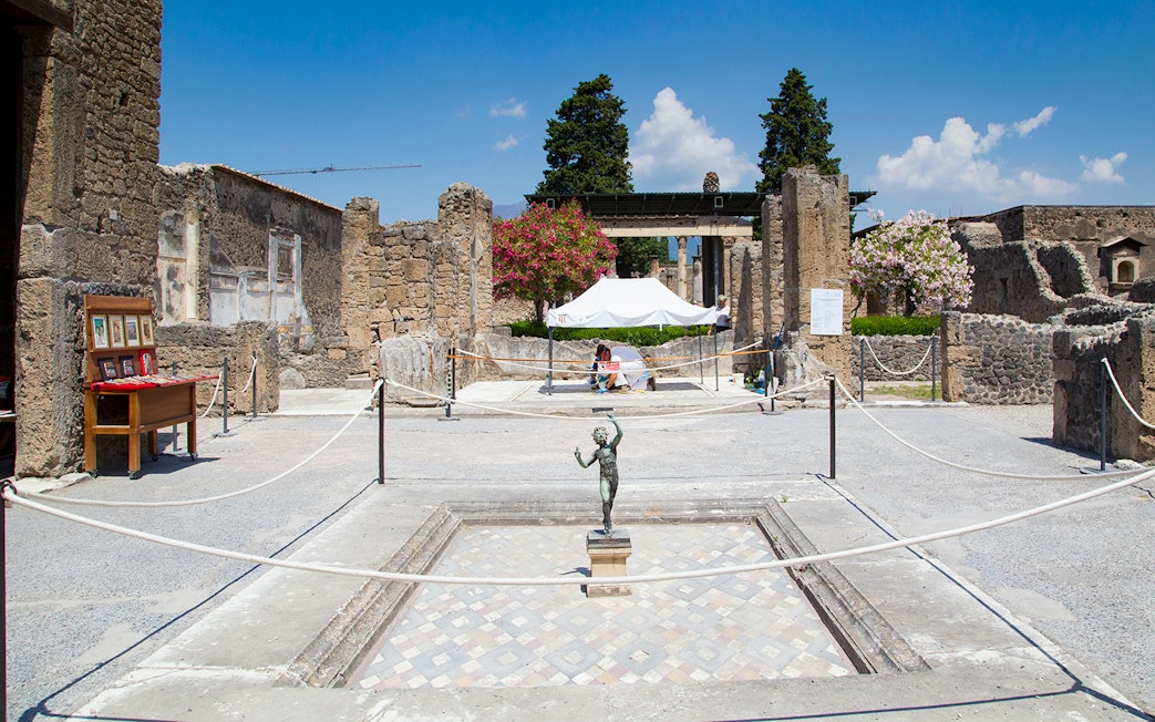 House of the Faun courtyard with bronze statue, Pompeii Ruins.