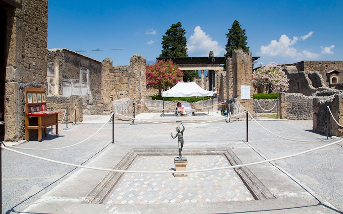 House of the Faun courtyard with bronze statue, Pompeii Ruins.