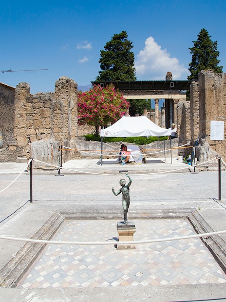 House of the Faun courtyard with bronze statue, Pompeii Ruins.