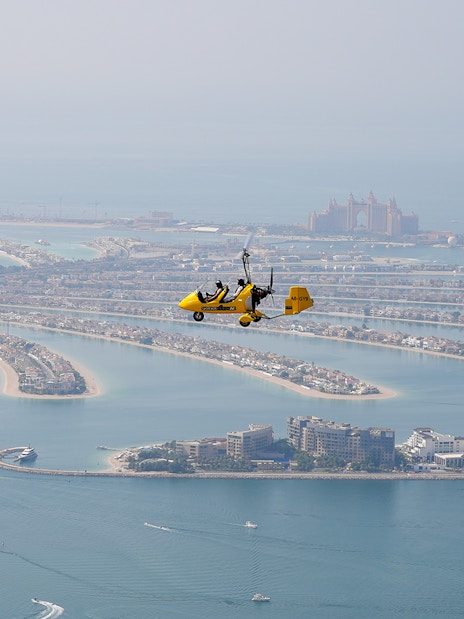 Gyrocopter flying over Palm Jumeirah in Dubai.