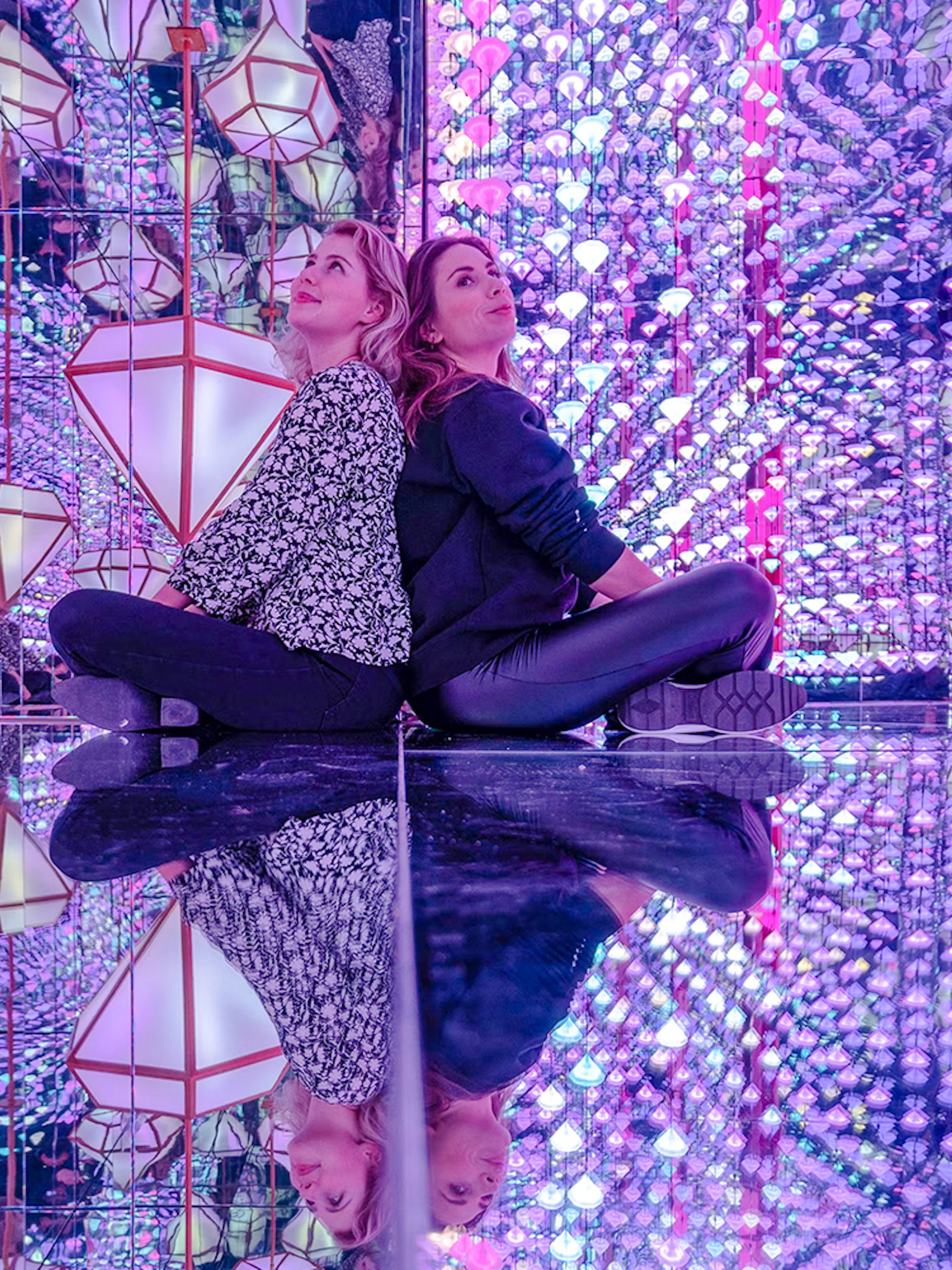 Visitors in mirrored room with colorful lights at Studio Irma, Moco Amsterdam.